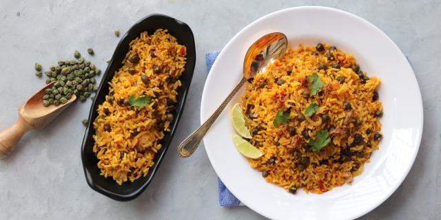 Indian cuisine - Chickpeas Biryani, chole Pulao. Garnished with fried onion, chopped coriander, and lemon wedges. Kala chana biryani. Along with copy space.  